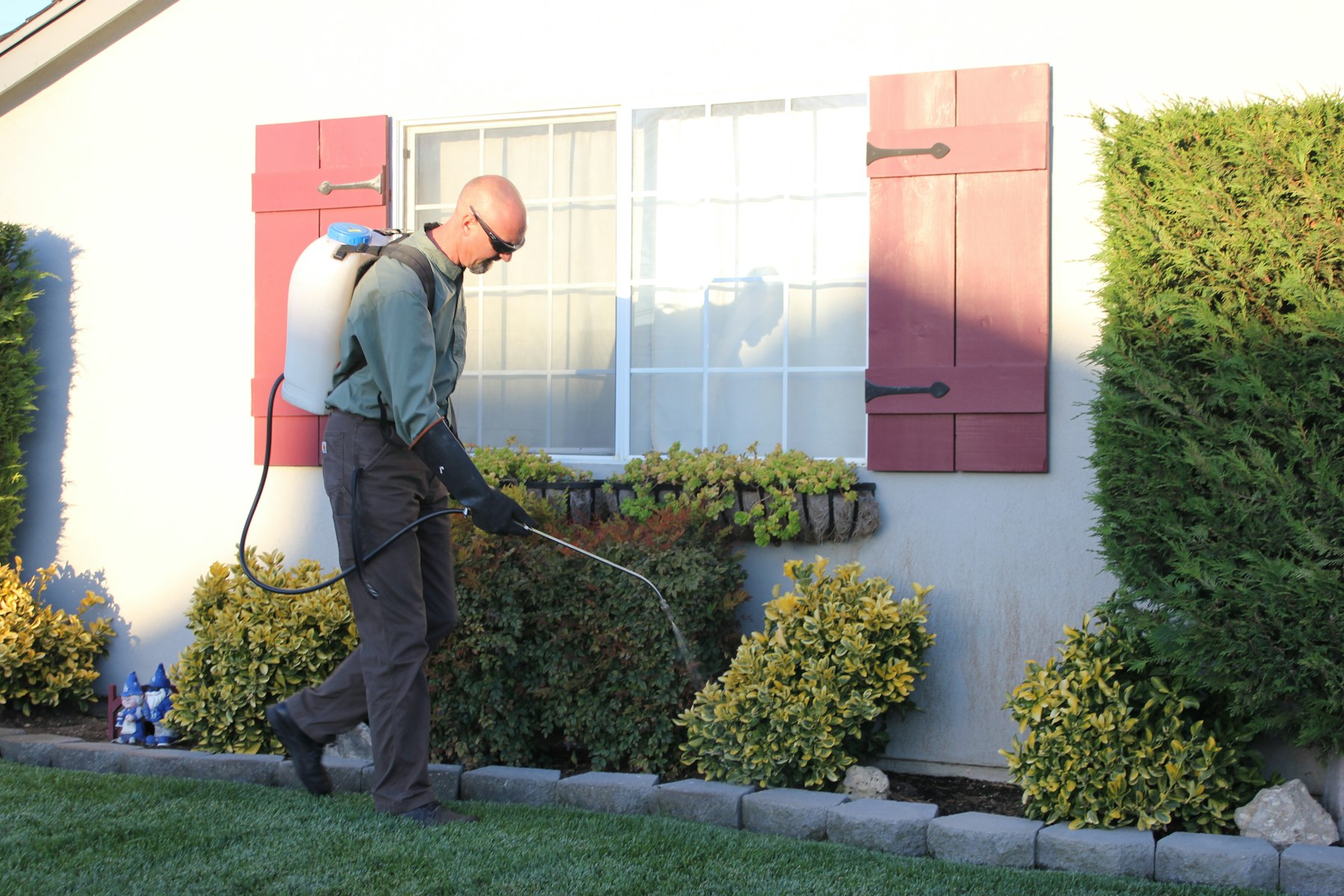 Hearthguard technician inspecting a property exterior
